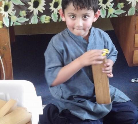Rushi builds with big wooden blocks